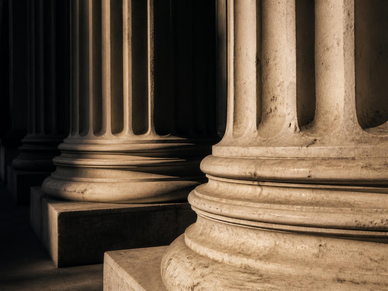 Detail of classical courthouse columns in raking light